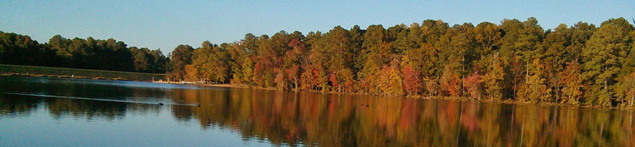sunlit autumn trees reflecting off the surface of Bond lake